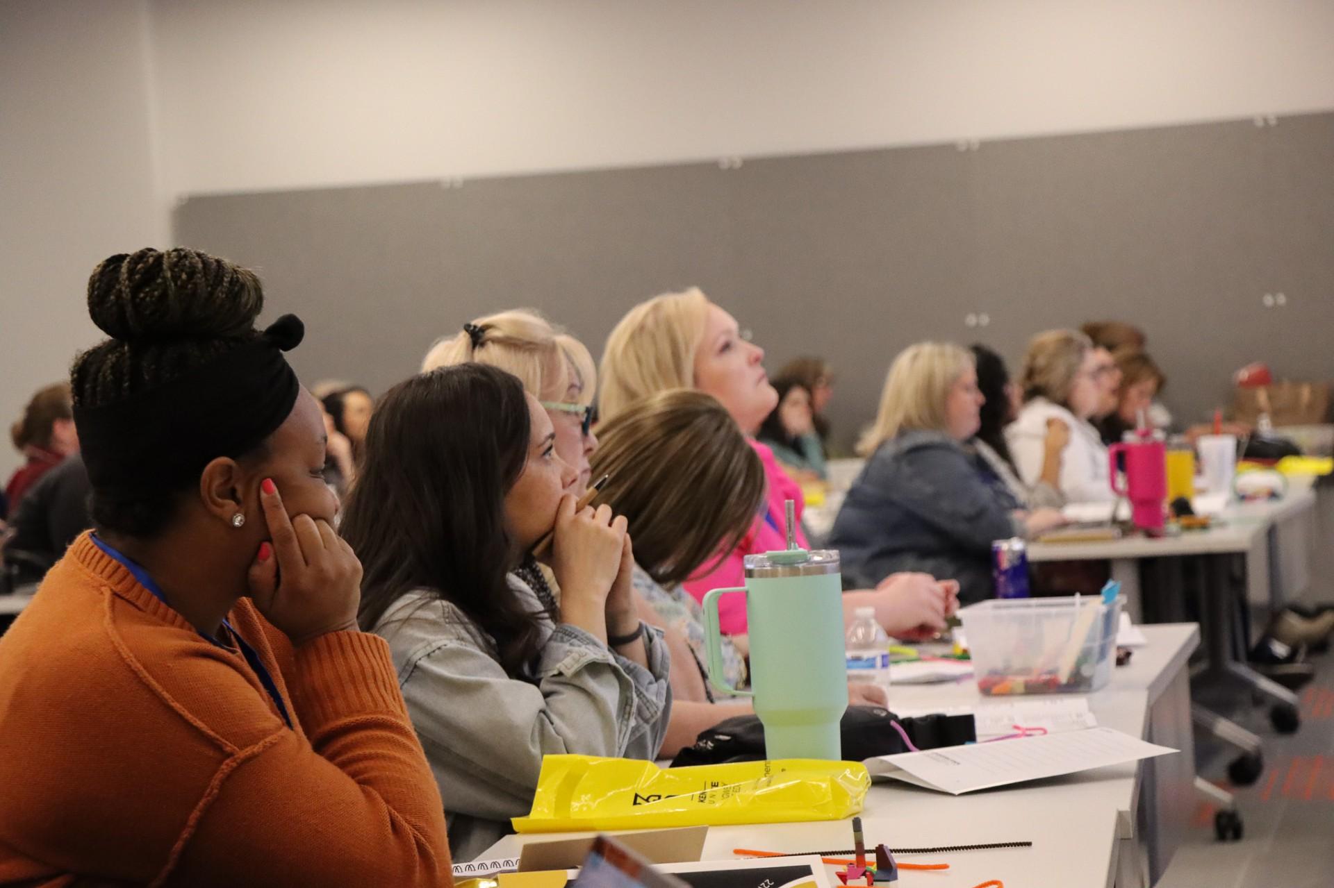  / A large group of people participating in the ESOL Conference.
