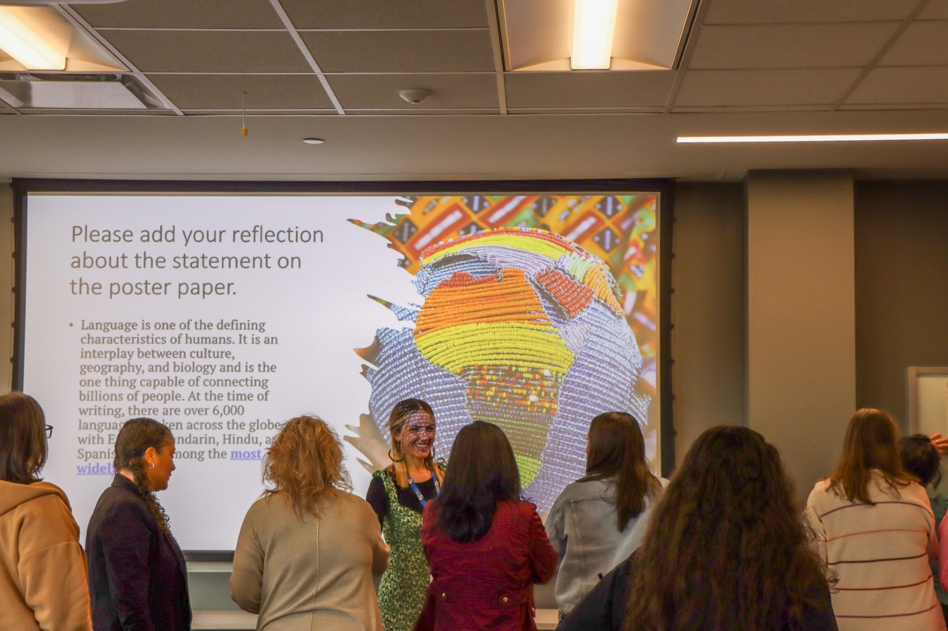  / A large group of people presenting at the ESOL Conference.