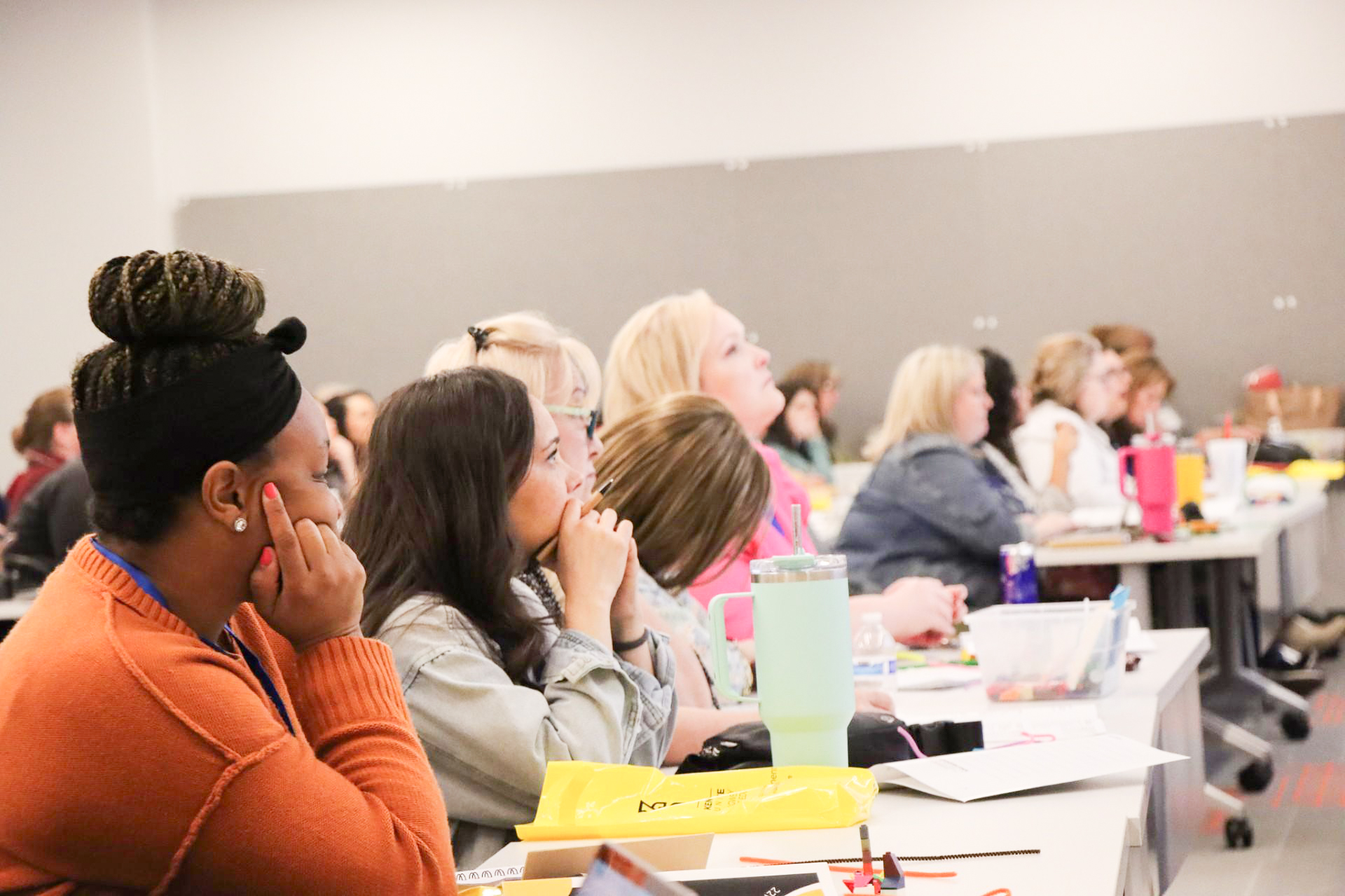 group of women sitting at table listeing to presenter