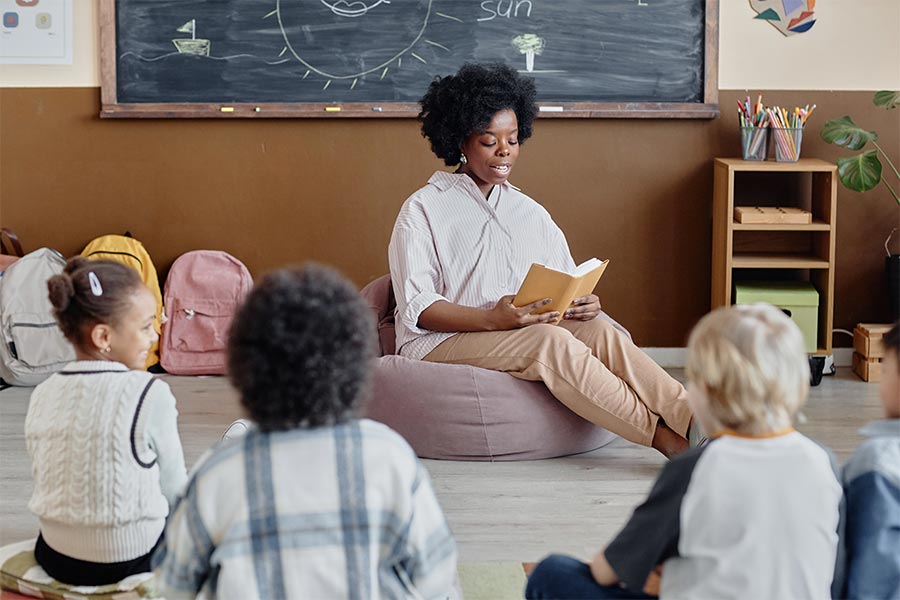 faculty reading to group of children.