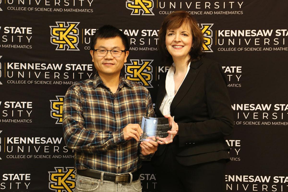  / Photo of the Outstanding Early Career Faculty Award winner, Dr. Min Wang, Assistant Professor of Mathematics, (left) and Dr. Marla Bell, Interim Dean (right)