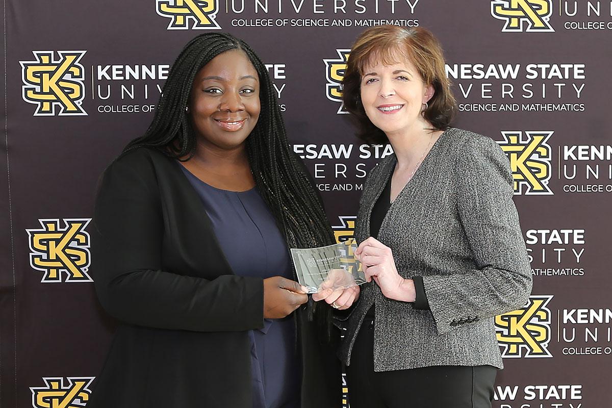  / Photo of the Outstanding Part-time Teaching Award winner, Kay Abikoye, Part-Time Instructor of Environmental Science (EEOB), (left) and Dr. Marla Bell, Interim Dean (right)
