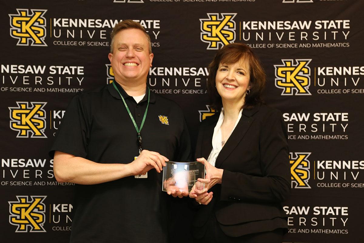  / Photo of the Outstanding Professional Service Award winner, Dr. Scott Nowak, Associate Professor of Biology, (left) and Dr. Marla Bell, Interim Dean (right)