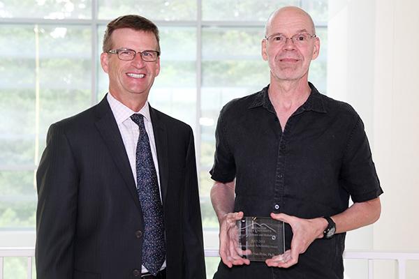  / Photo of Mark Anderson (left) and Distinguished Scholarship Award recipient, Michael Van Dyke, Ph.D., (right) Associate Professor of Biochemistry (CHEM)