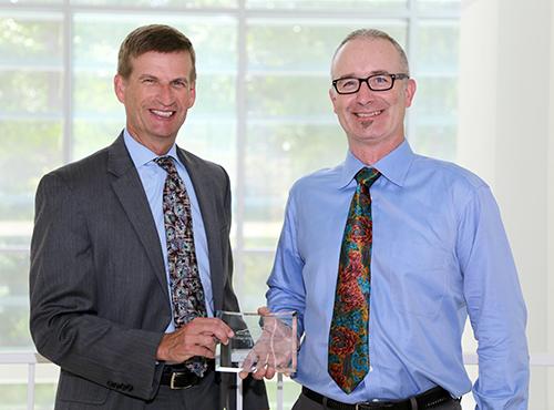  / Photo of Mark Anderson (left) and Distinguished Mentoring Award recipient, Martin Hudson, Ph.D., Associate Professor of Biology, Department of Molecular and Cellular Biology.