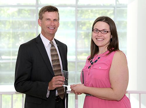  / Photo of Mark Anderson (left) and Distinguished Service Award recipient, Kimberly Cortes, Ph.D. (right), Assistant Professor of Chemistry Education, Department of Chemistry and Biochemistry.