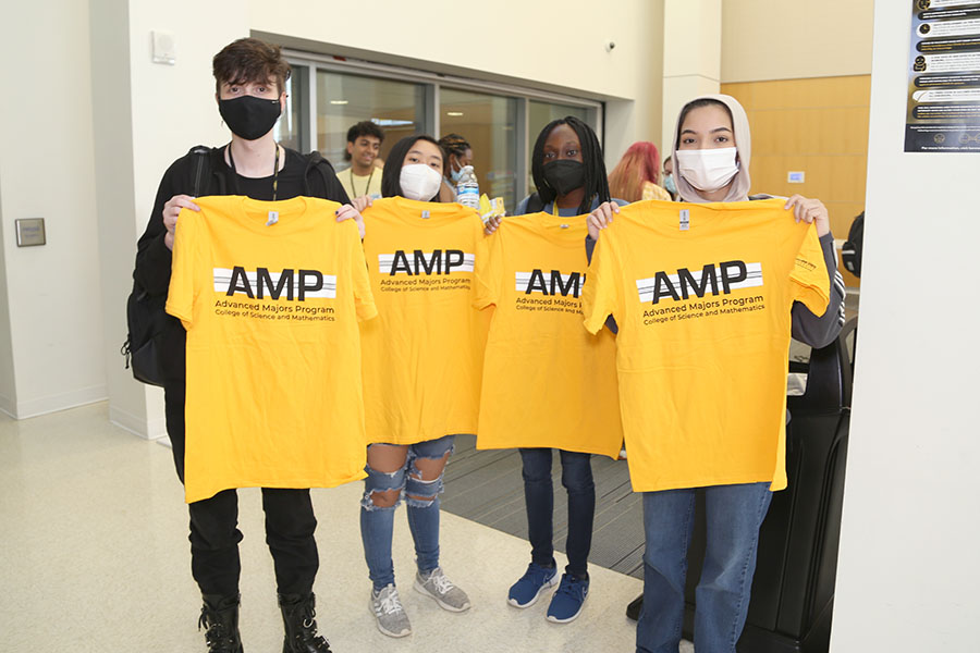  / Students holding up their new Advanced Majors Program (AMP) T-shirts at the Backstage Pass event