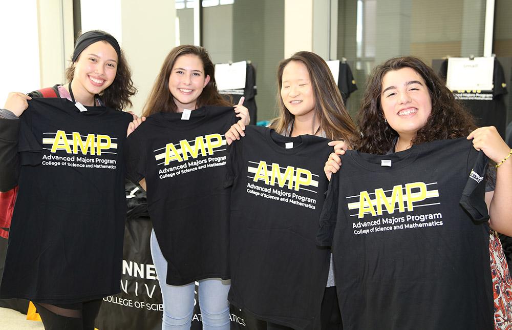  / Students holding up their new Advanced Majors Program (AMP) T-shirts at the Backstage Pass event