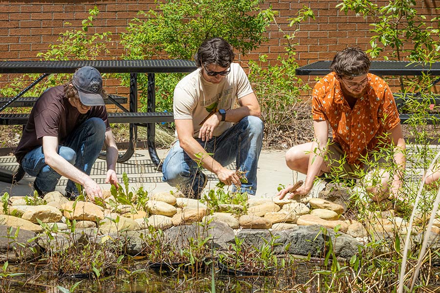 Faculty and students in the Oasis outdoor classroom / Kennesaw State students work in the Oasis outdoor classroom. Money for the space was donated by Joseph Cook.