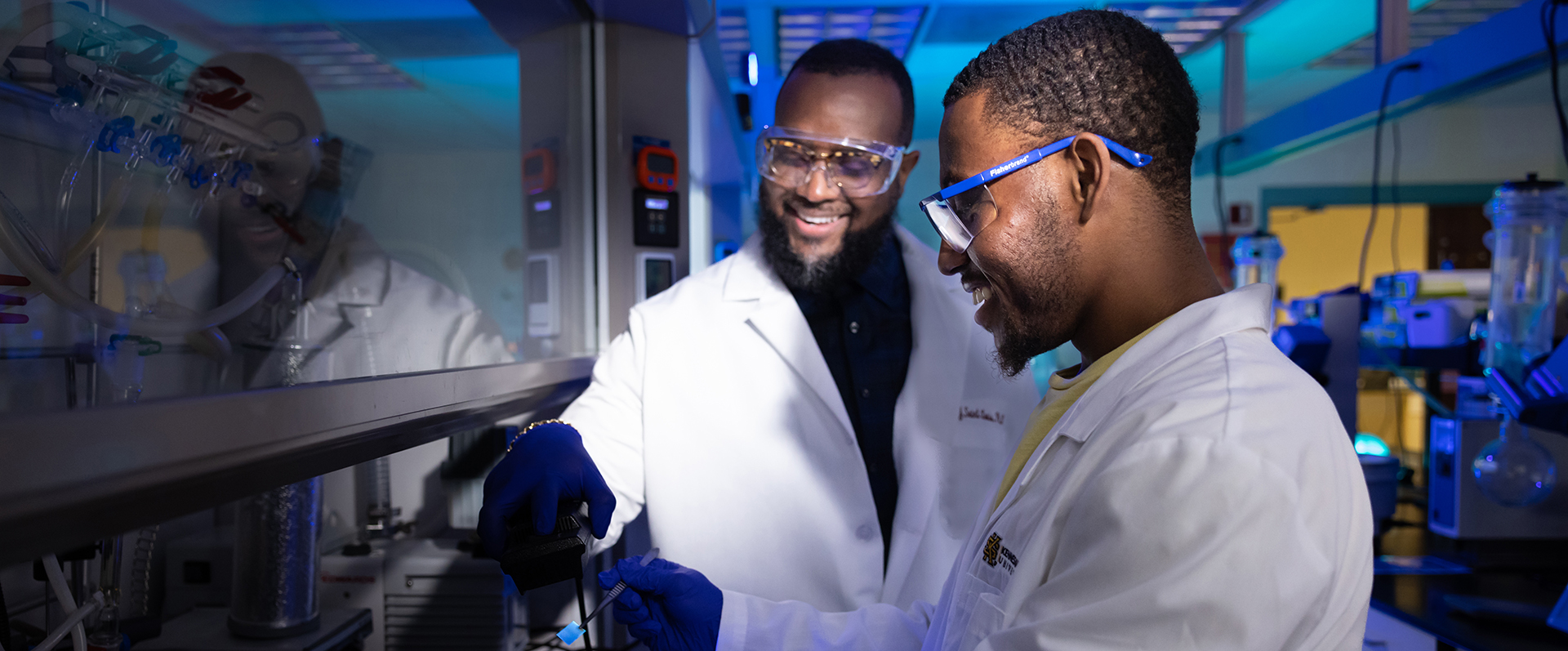 Graduate student working on research in a lab with a faculty mentor