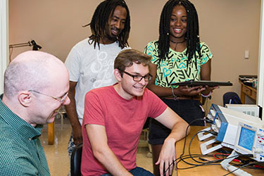 ksu physics students with a professor in the lab