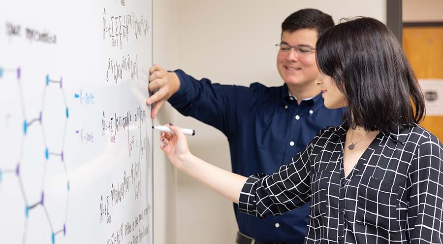 ksu physics students with a professor in the lab