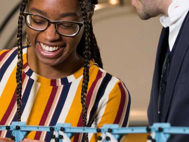 Woman is looking down and smiling at project