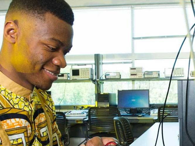 Man looking at a computer monitor with a wire hanging down infront of it