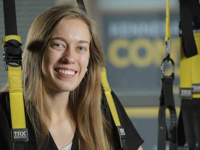 Woman is strapped into safety gear