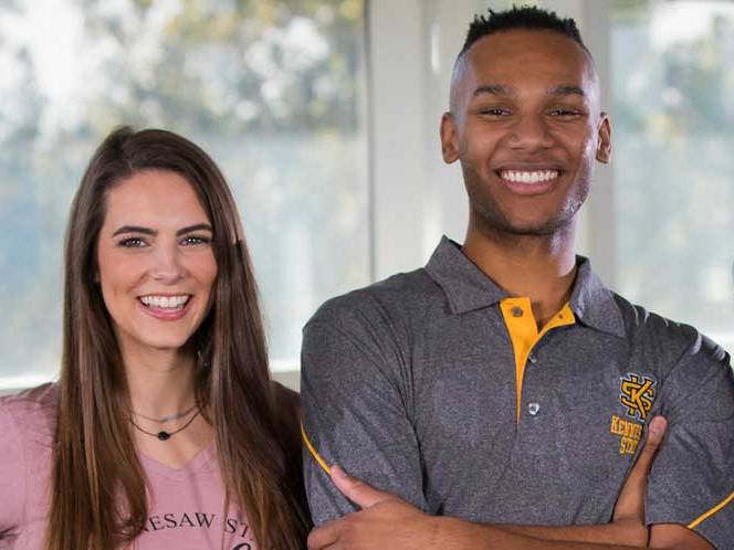 Man and woman standing together smiling for a picture