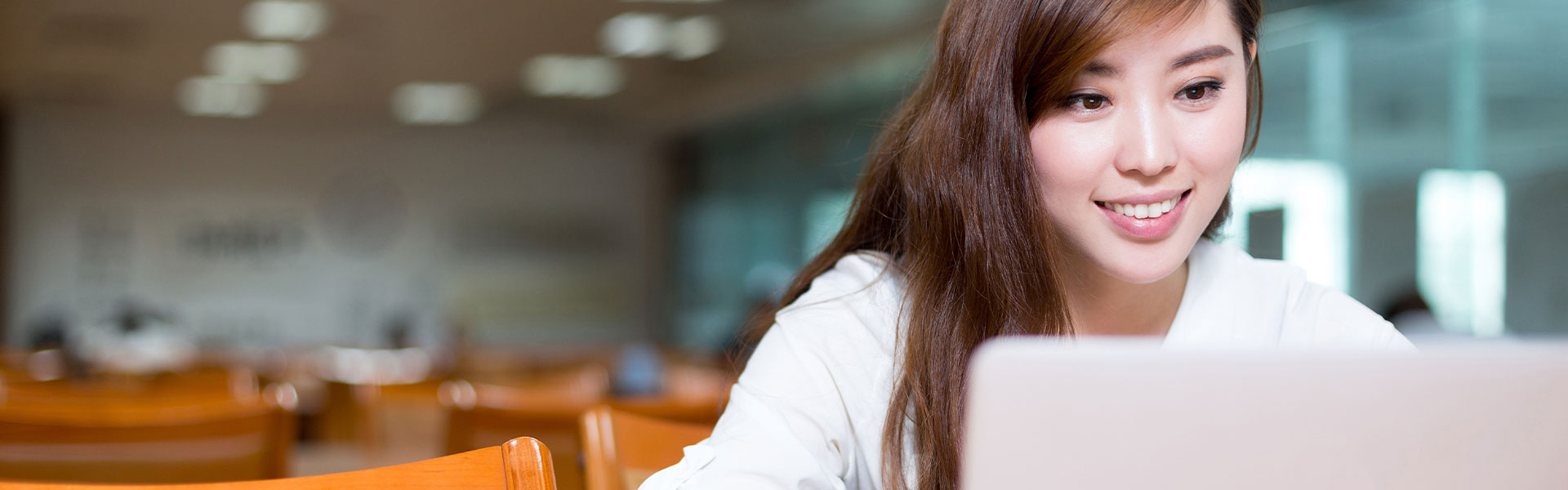 Young woman focusing on laptop