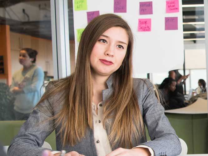 Business student sitting down smiling for a picture