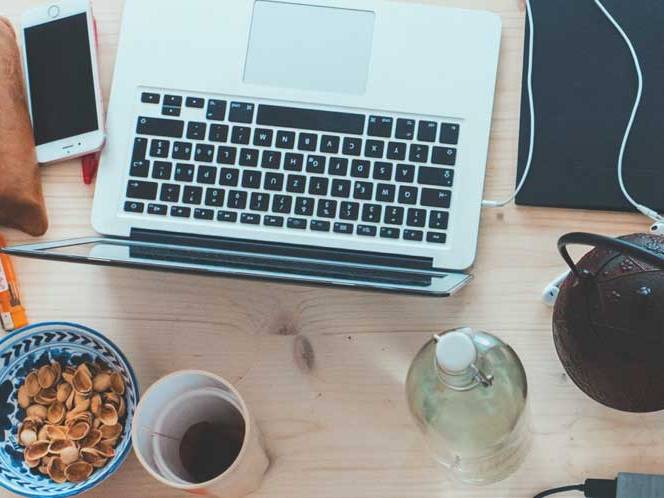 Top view of computer,snacks, and coffee