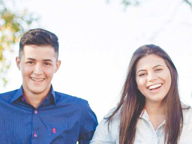 Man and woman standing together smiling for a picture