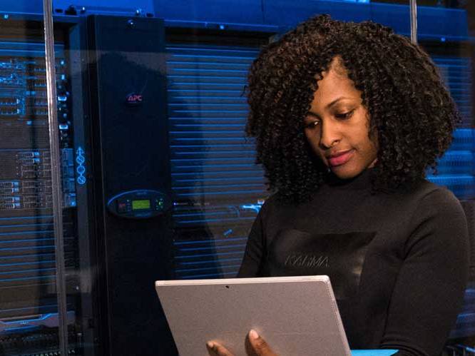 Woman standing using her laptop