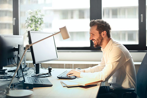 Man at desk using his computer