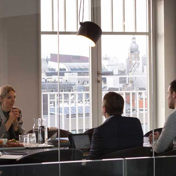Business man and woman sitting at a desk communicating