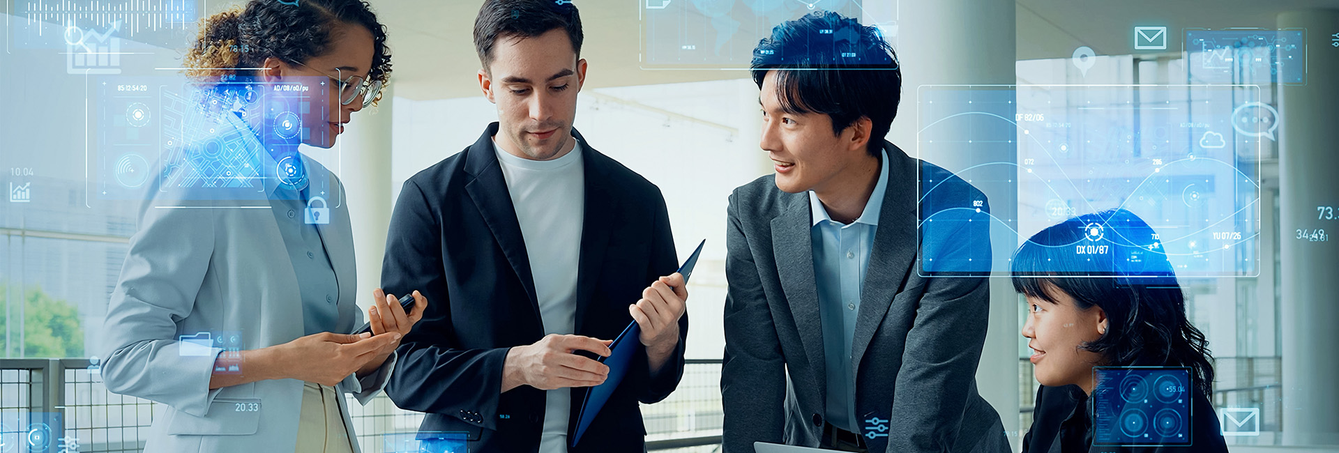 4 people working together in suits with computer screen overlay