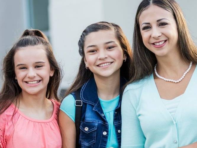 Woman and two younger children smiling for picture