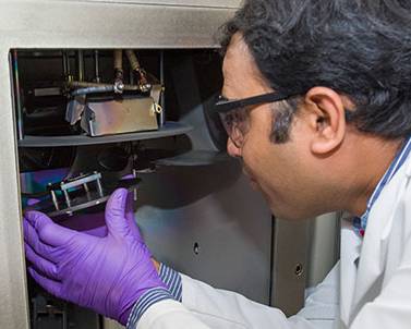 Man adjusting scientific machine