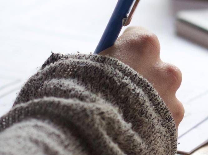 Student is writing with a pen