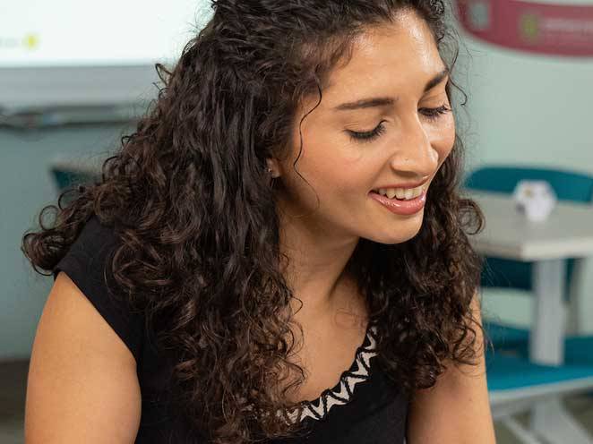 Young woman smiling and looking down