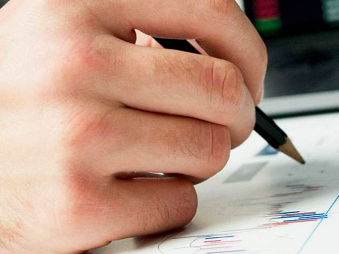 Student hovering over graph with a pencil