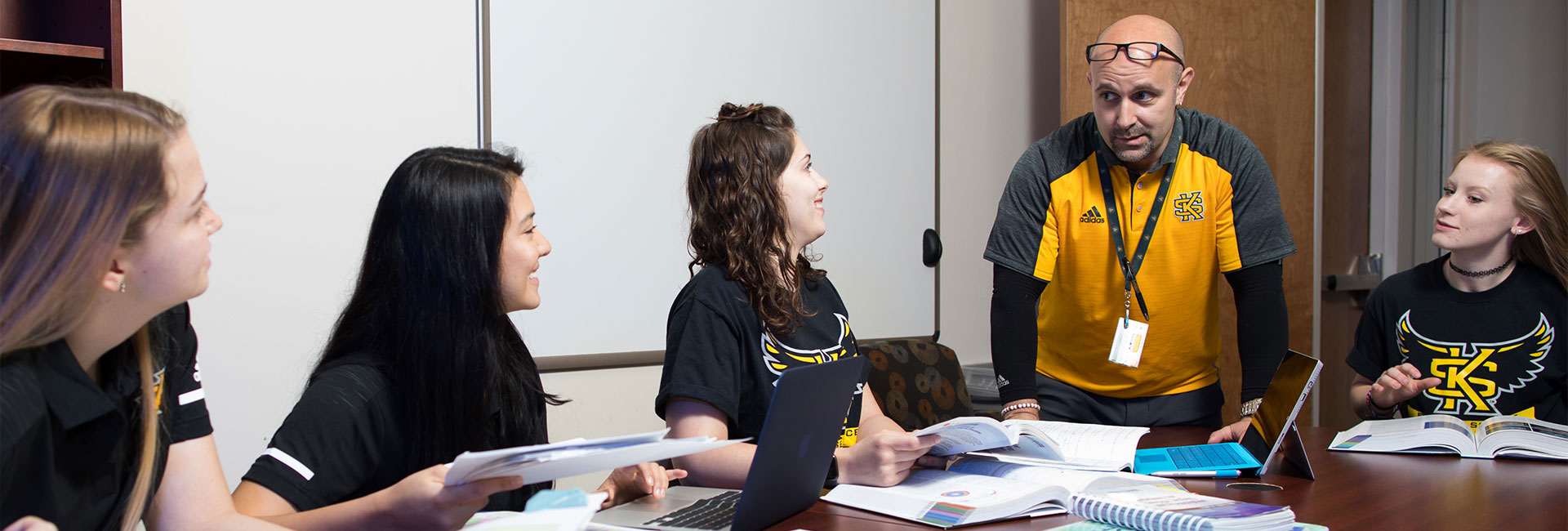 Students at a desk with teacher