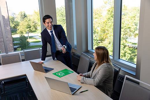 Two teachers talking at a desk