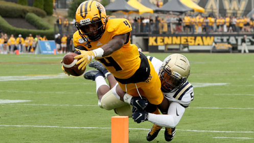 KSU Football player scoring a touchdown during the homecoming game of 2024.