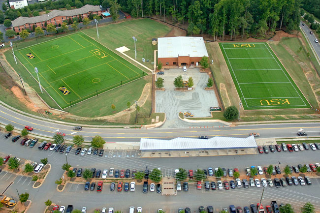 The image shows an aerial view of the KSU Owl Nest, featuring two large artificial turf fields marked with "KSU" and the university's owl logo. 