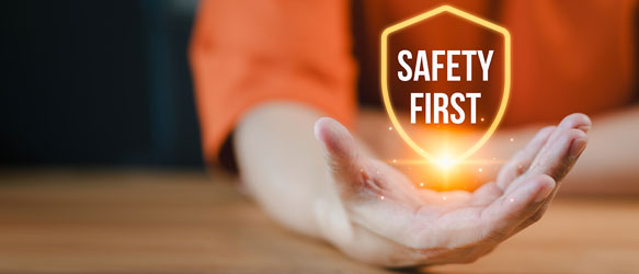 A hand firmly holds the phrase "Safety First," emphasizing the importance of safety in various contexts.