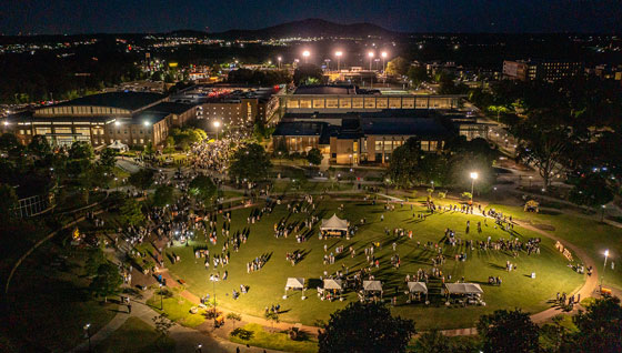 A photo of KSU event at night on the kennesaw campus green.