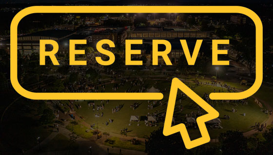 A sunset backdrop of a large event at KSU, featuring an overlay of an event reserve button graphic.