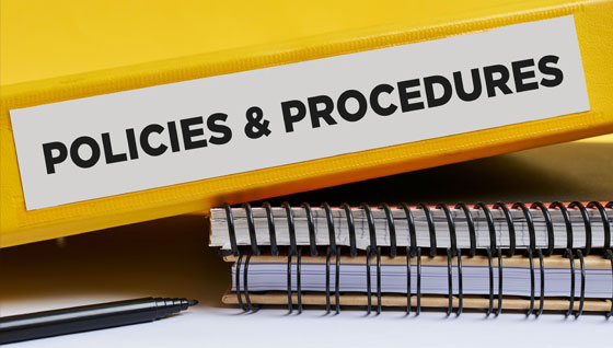 Notes books displaying "Policies and Procedures," showcasing organized sections that detail rules and guidelines for staff compliance.