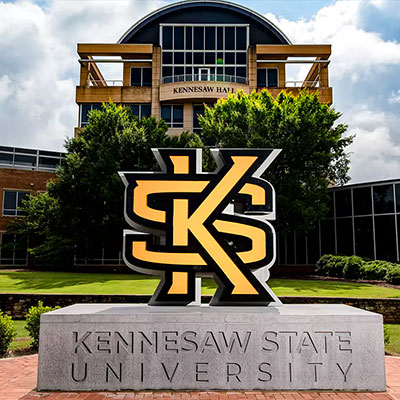 KSU Satue of the Kennesaw State University logo with Kennesaw Hall in the background