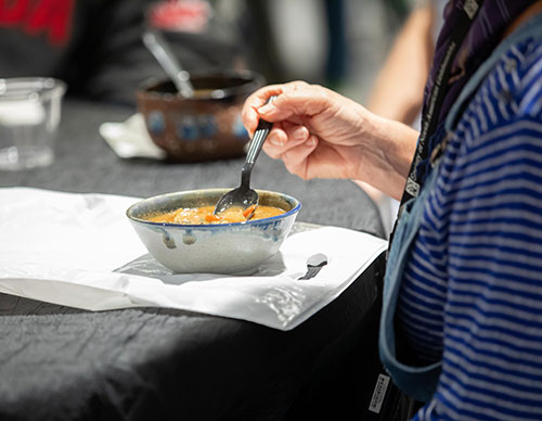 close up of ceramic soup bowl with spoon