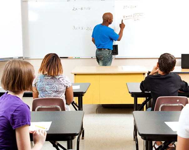 instructor using white board in classroom