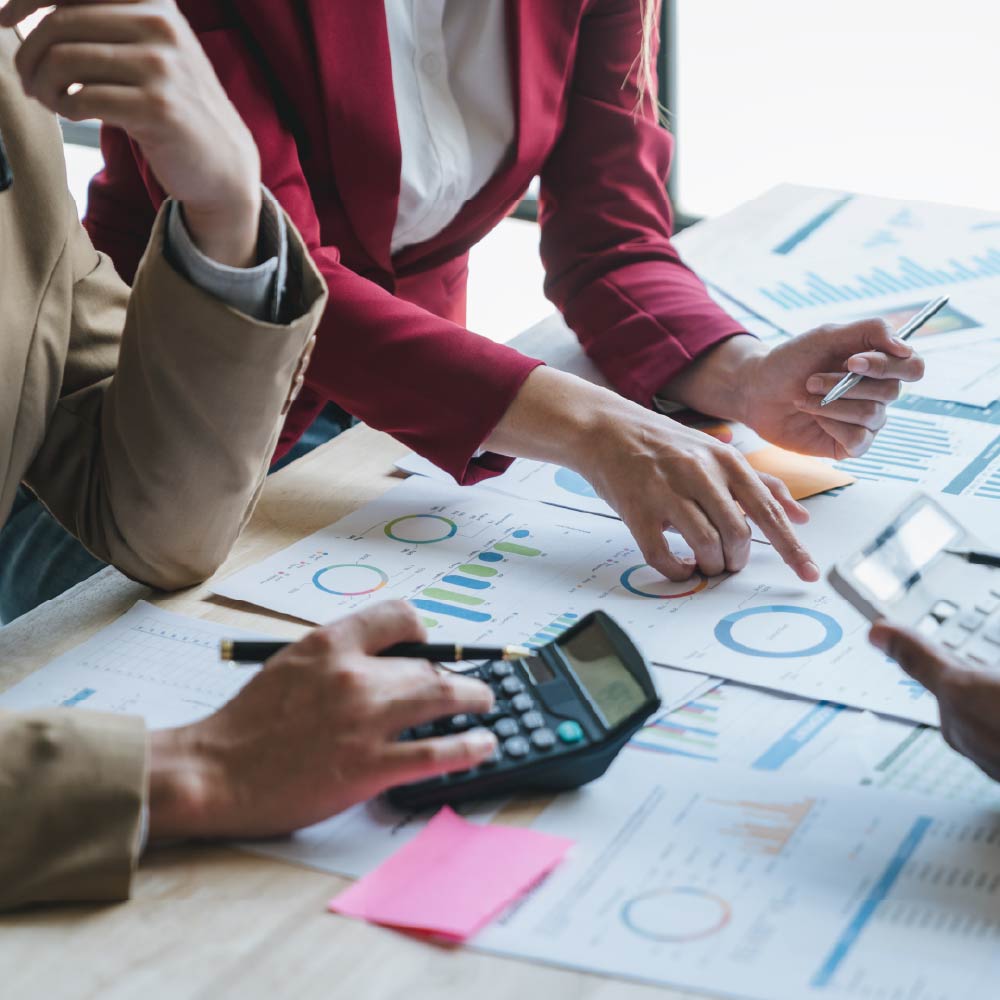business women evaluating charts and graphs at a table