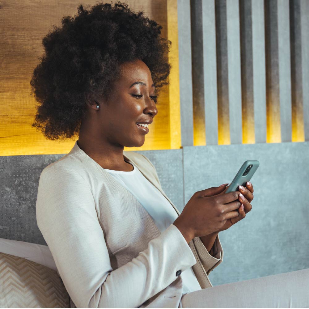 Woman sitting on a couch looking at her phone