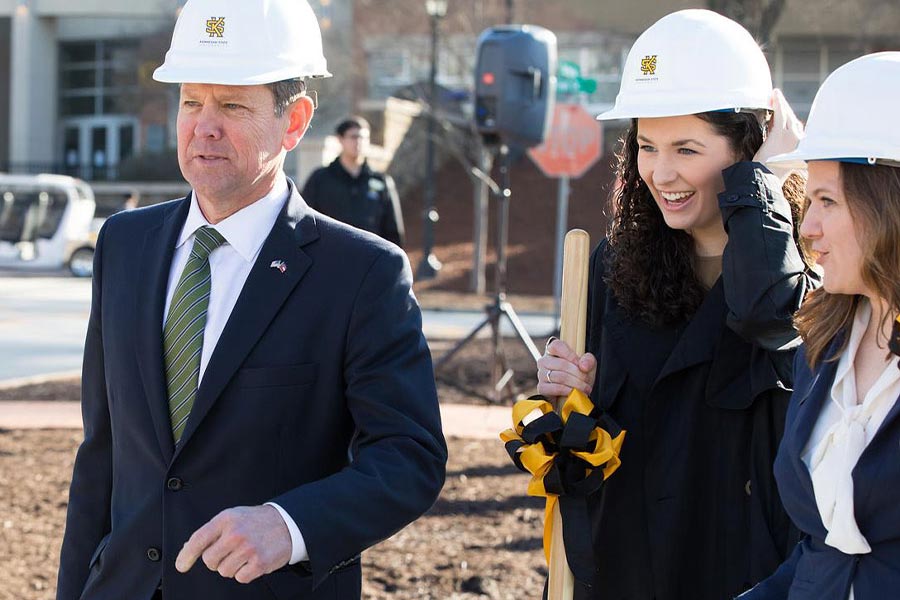 Governor Kemp with KSU employees wearing hard hats on constuction site