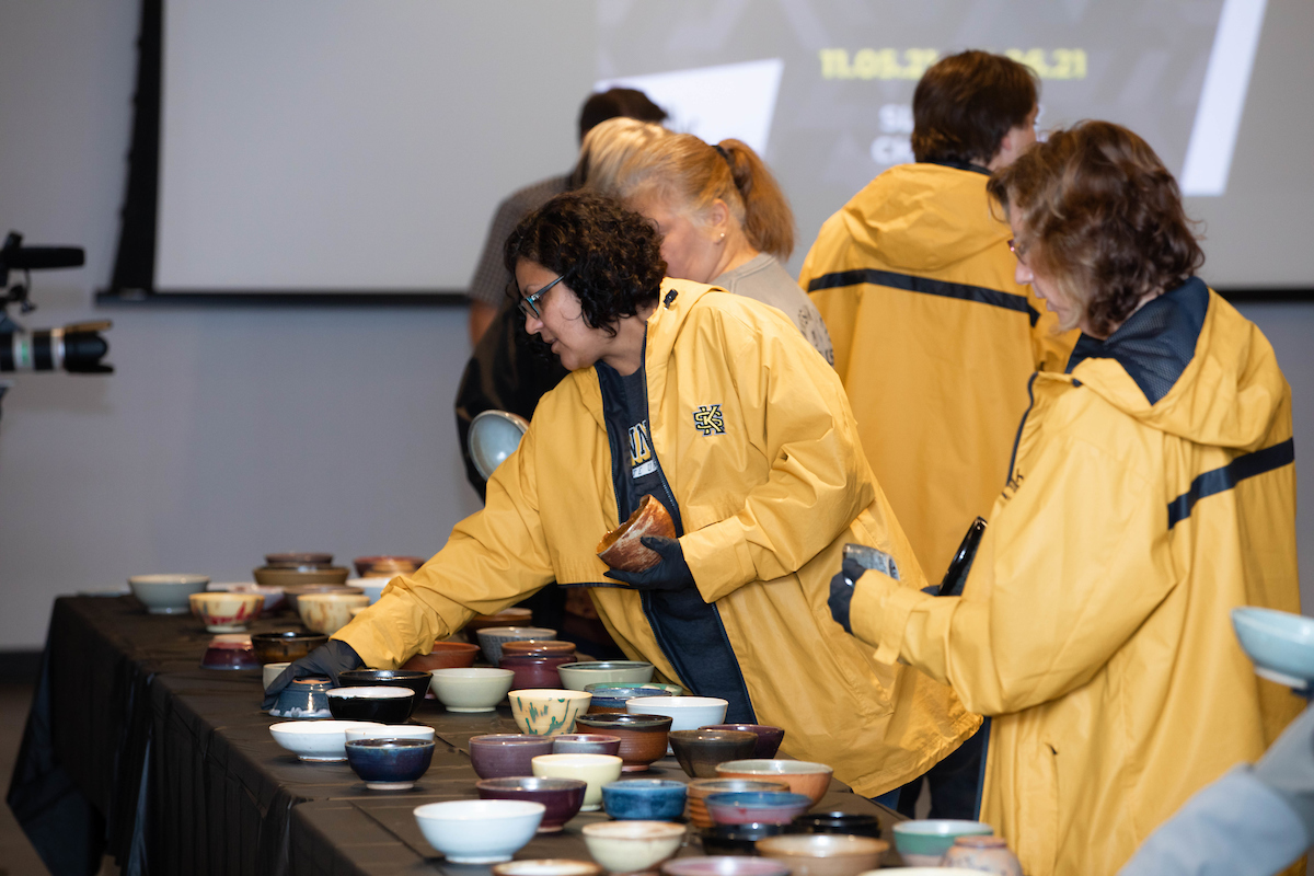 ksu staff viewing empty bowls exhibit