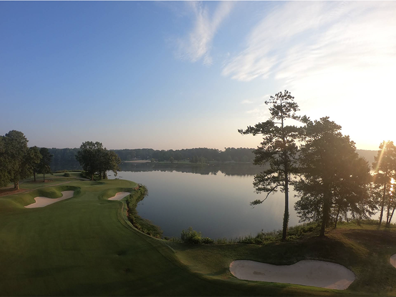 a golf course with a view of a lake