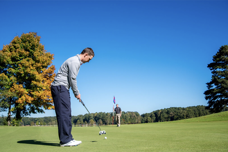 a golder tees up for a drive
